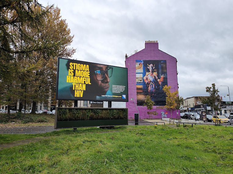 An outoodr digital billboard next to a house showing our anti-stigma messaging.