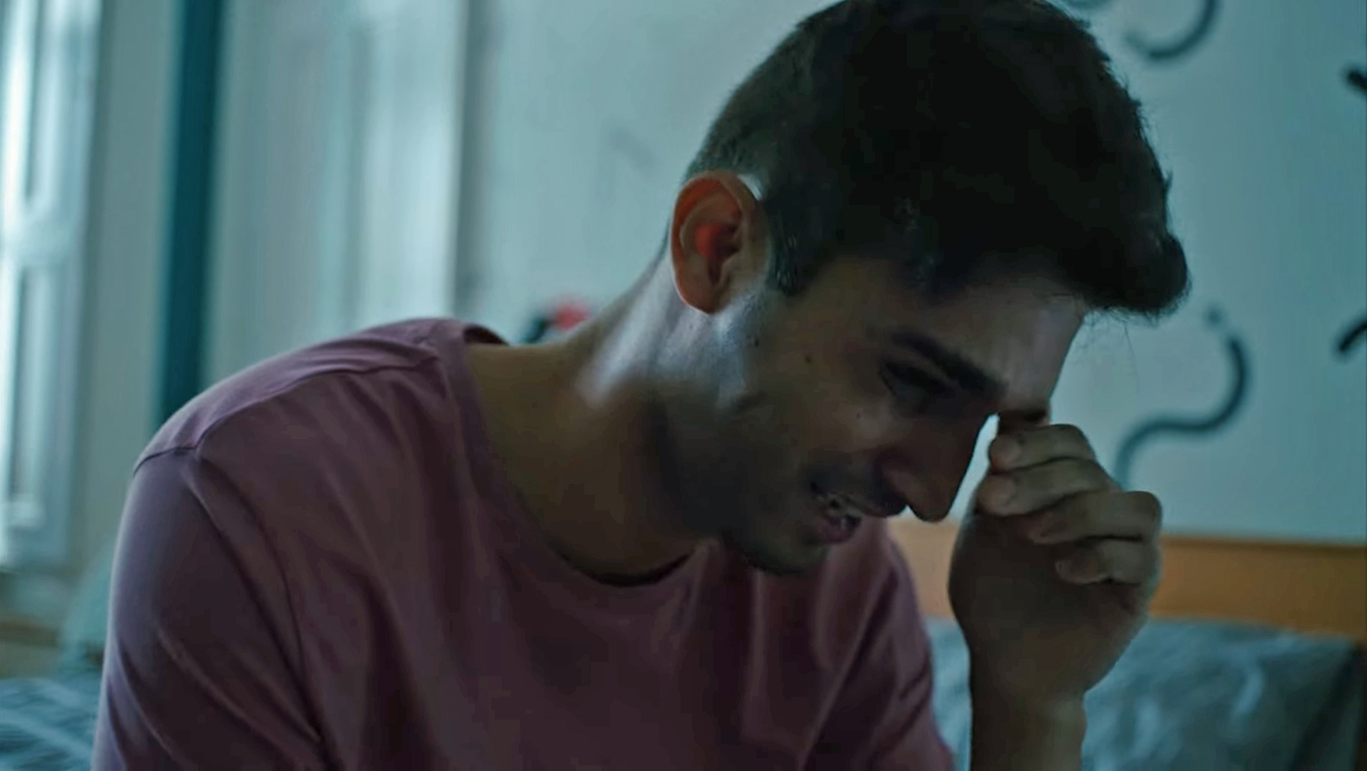 Man crying, with the text "stigma is more harmful than HIV"