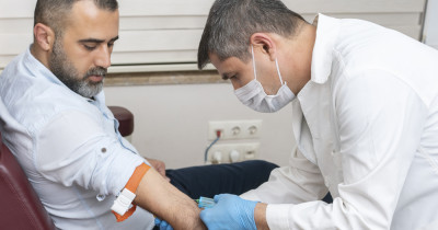 Doctor injecting into patient arm