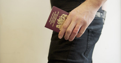 Man holding UK passport