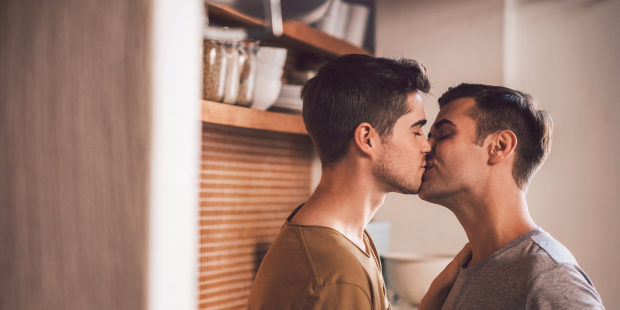Two men kissing