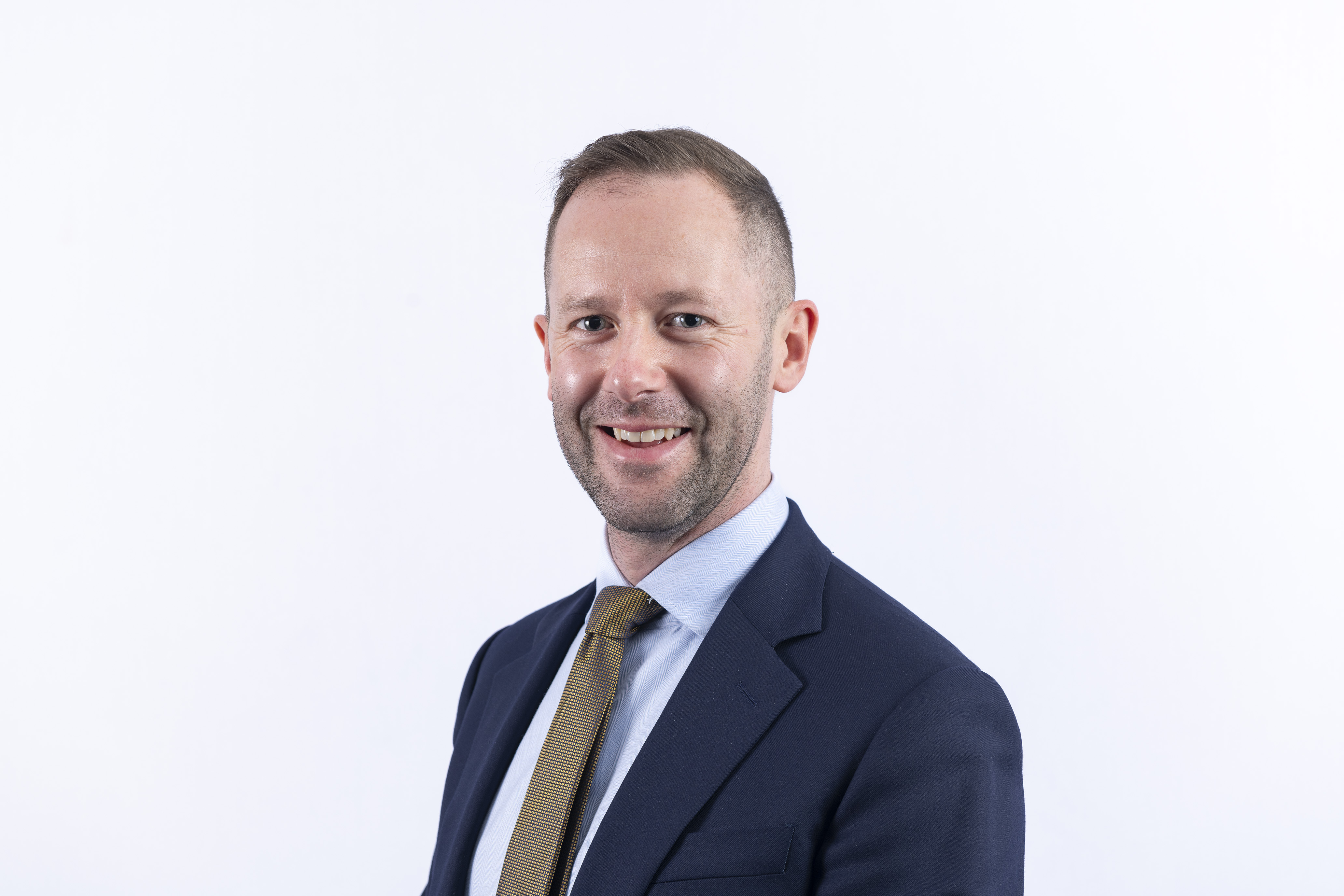 A professional headshot of Tomas Waite OBE. A professional headshot of Tomas Waite OBE.