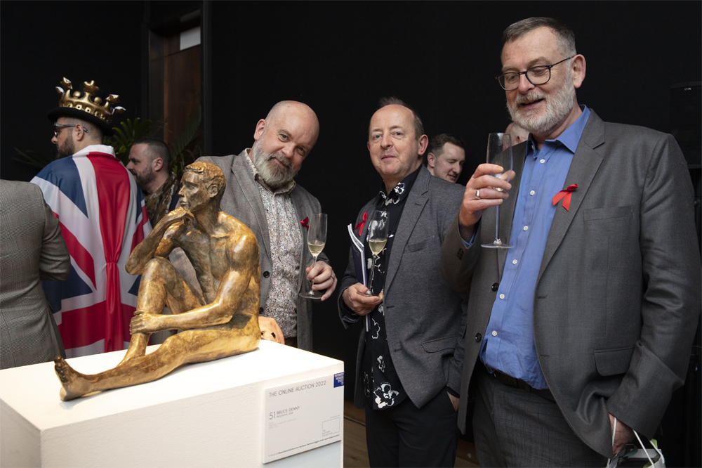The Auction 2022 people standing around sculpture
