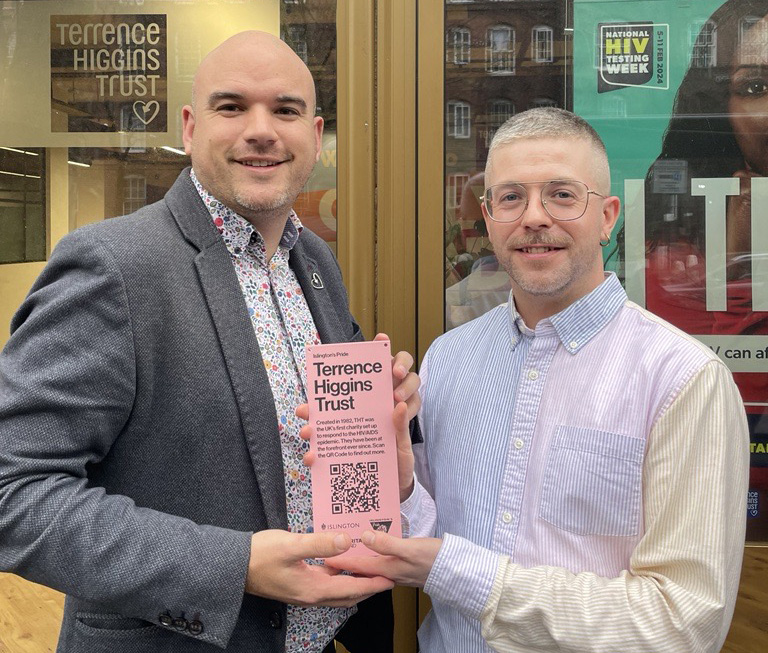 Richard Angell receiving pink plaque from Seán McGovern outside Cally Yard office