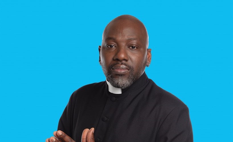 Reverend Jide Macaulay against a blue background.