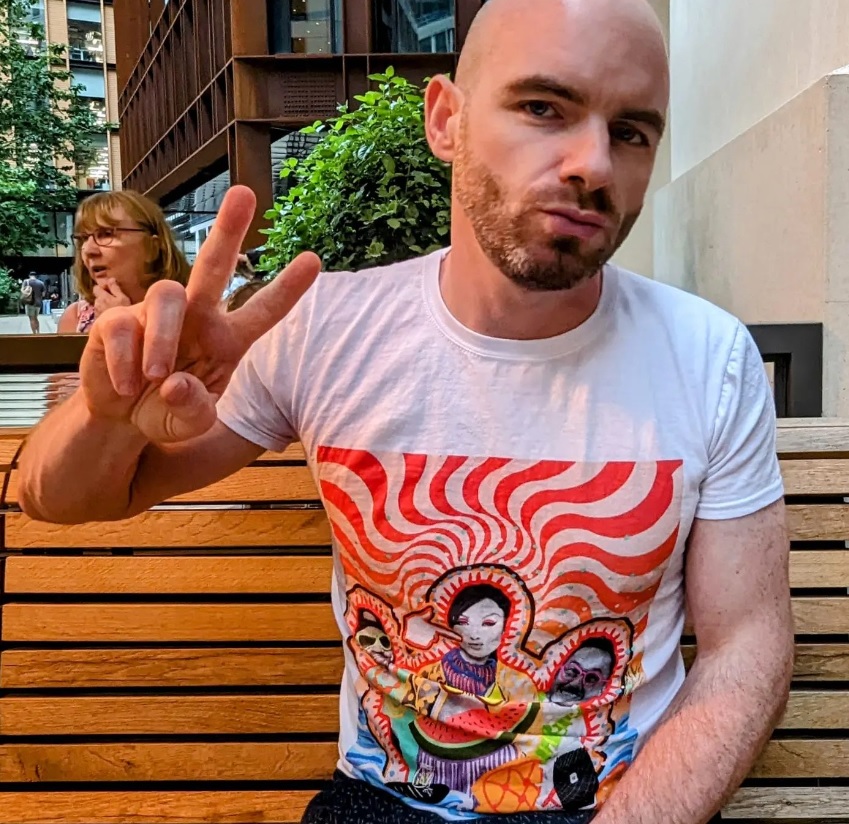 Liam wearing T-Shirt with one of two artworks by Amog Lux to mark their trip