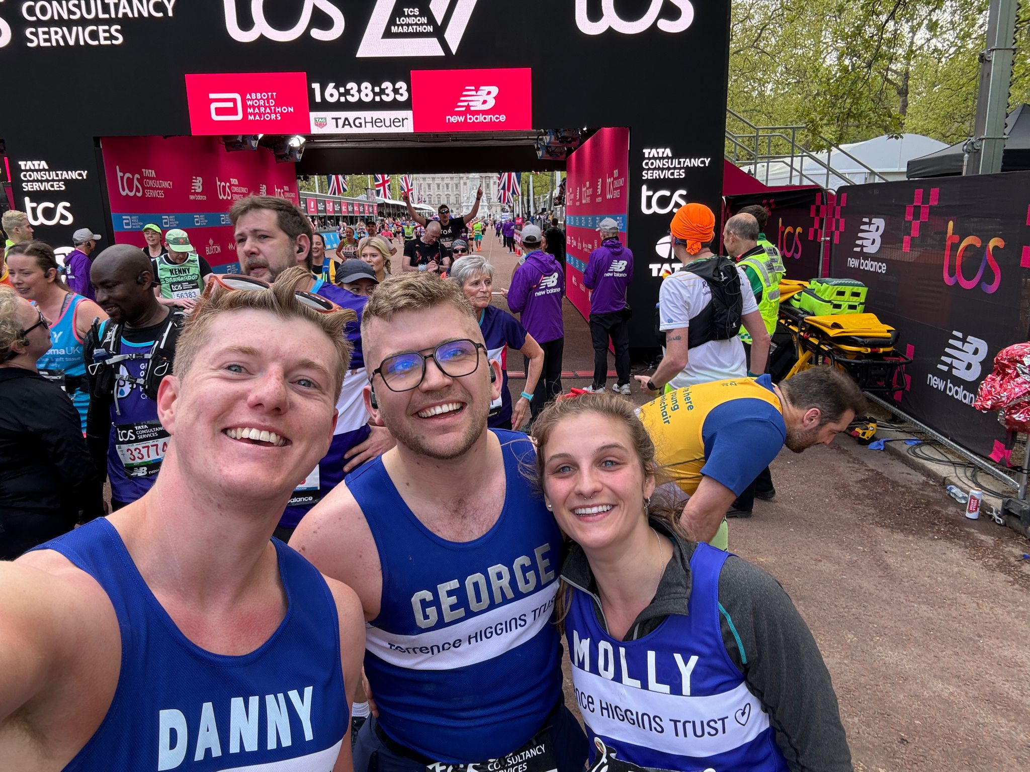 Three Terrence Higgins Trust marathon runners smiling for a selfie. Three Terrence Higgins Trust marathon runners smiling for a selfie.