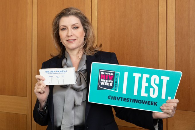 Penny Mordaunt holding up a test kit during National HIV Testing Week