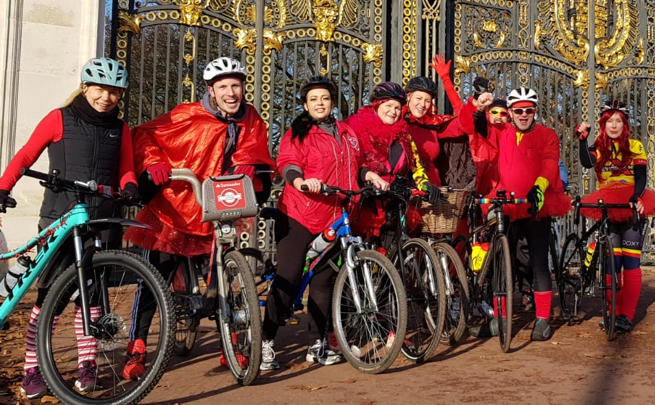 Cyclists wearing red in front of gates Cyclists wearing red in front of gates