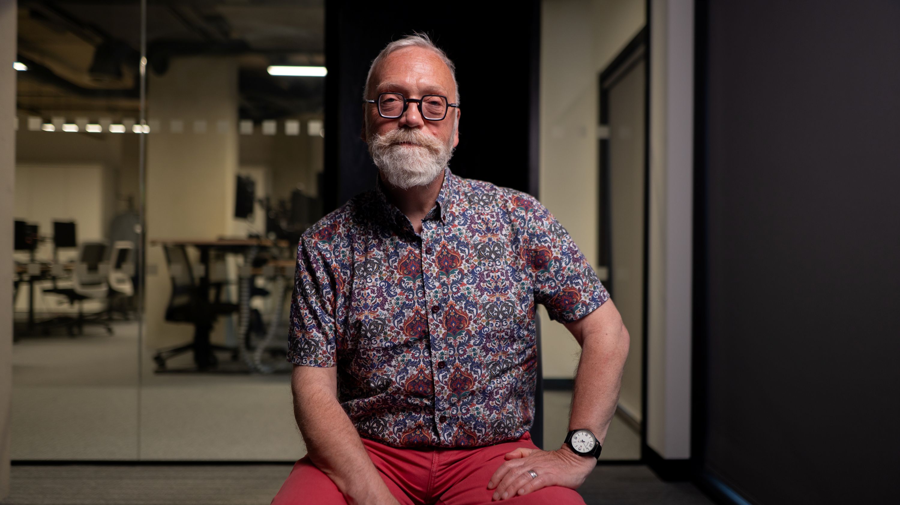 An elderly bespectacled and bearded man.