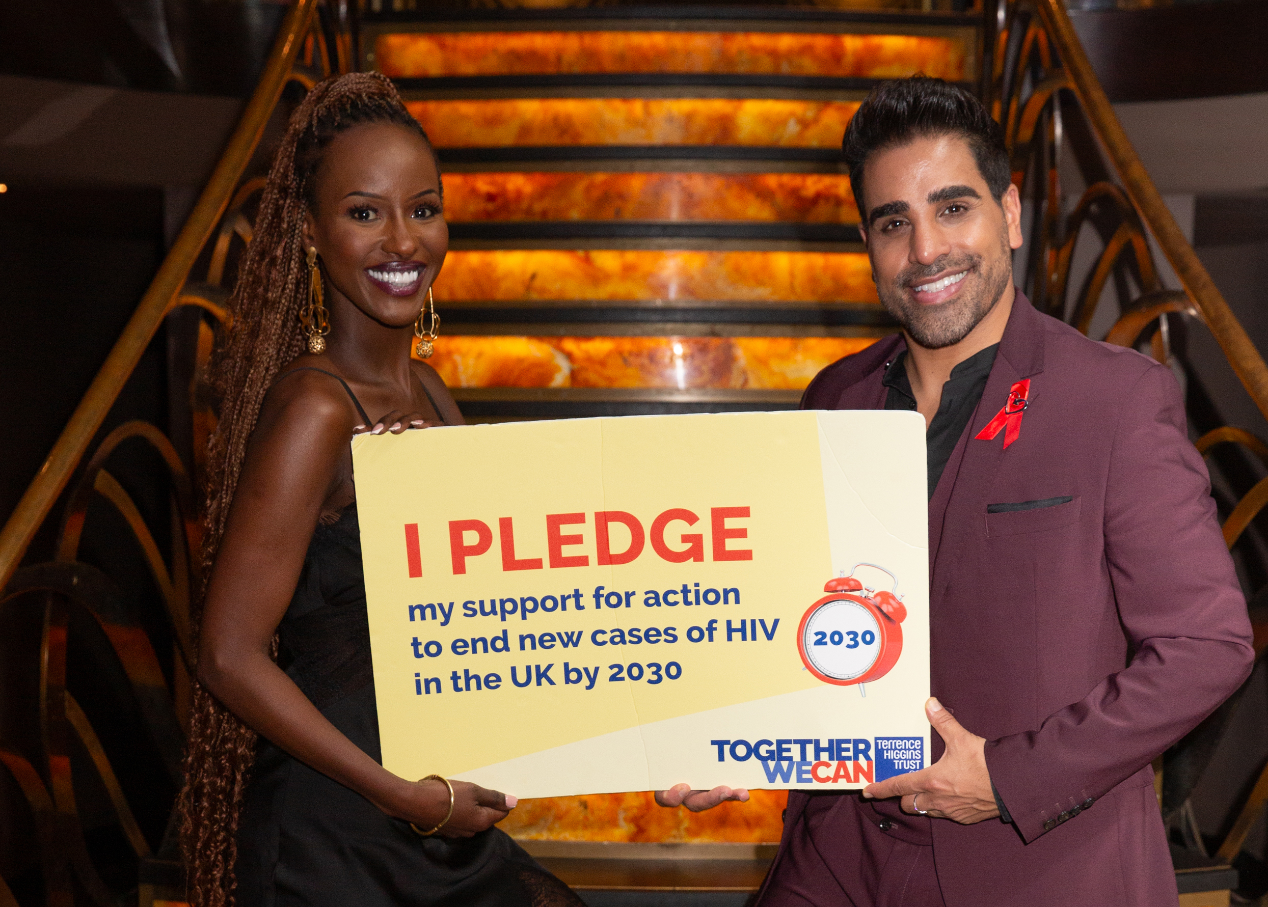 Sarah Mulindwa and Dr Ranj holding pledge to support for action to end new cases of HIV in the UK by 2030