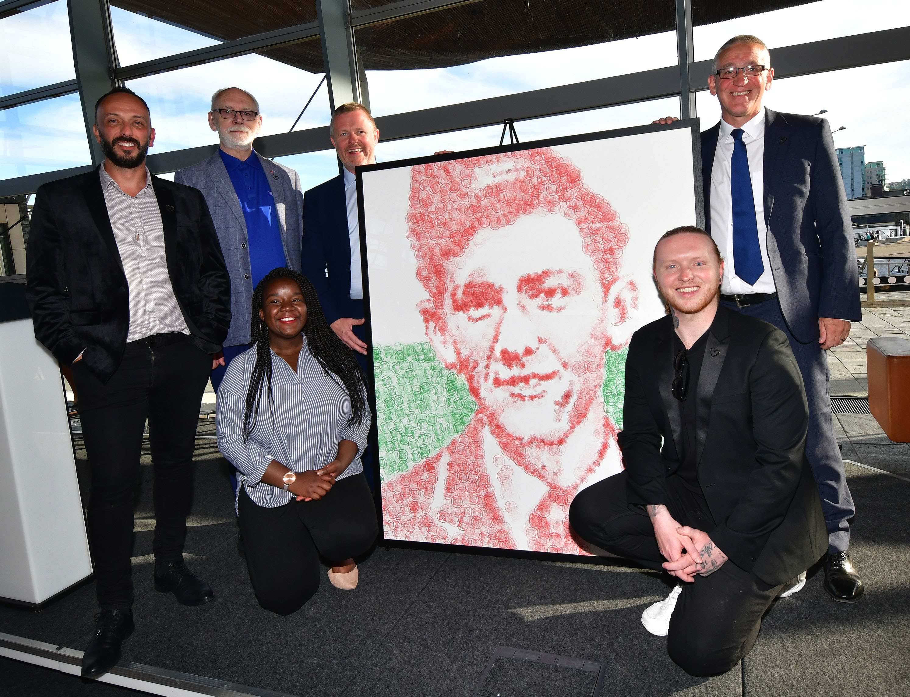 40 years of HIV at the Welsh Senedd group photo and Terry Higgins painting