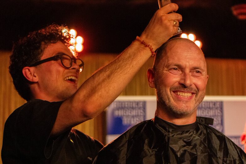 A Terrence Higgins Trust supporter have their head shaved on stage at the Royal Vauxhall Tavern.