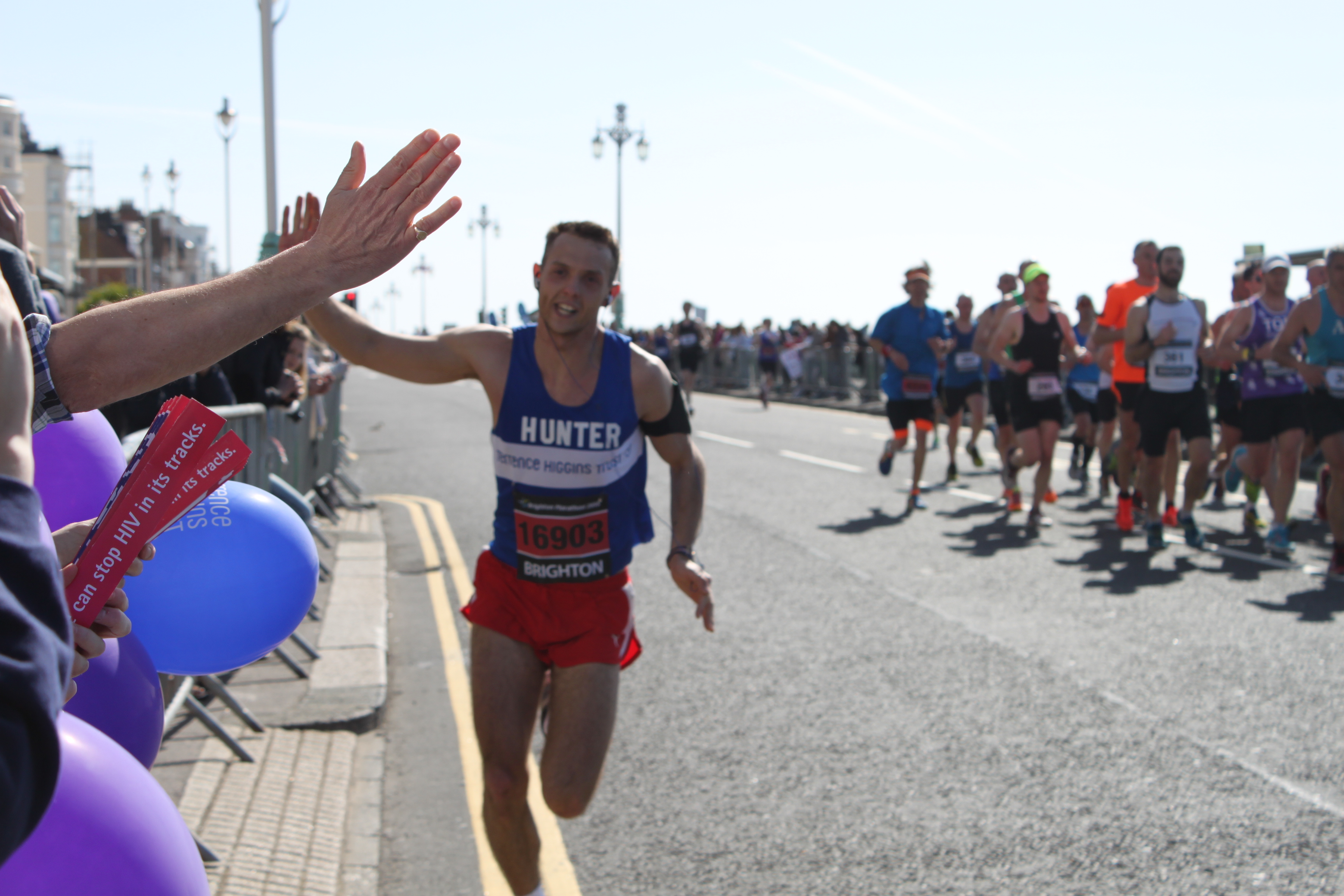 Marathon runner high-fiving crowd in Brighton Marathon runner high-fiving crowd in Brighton