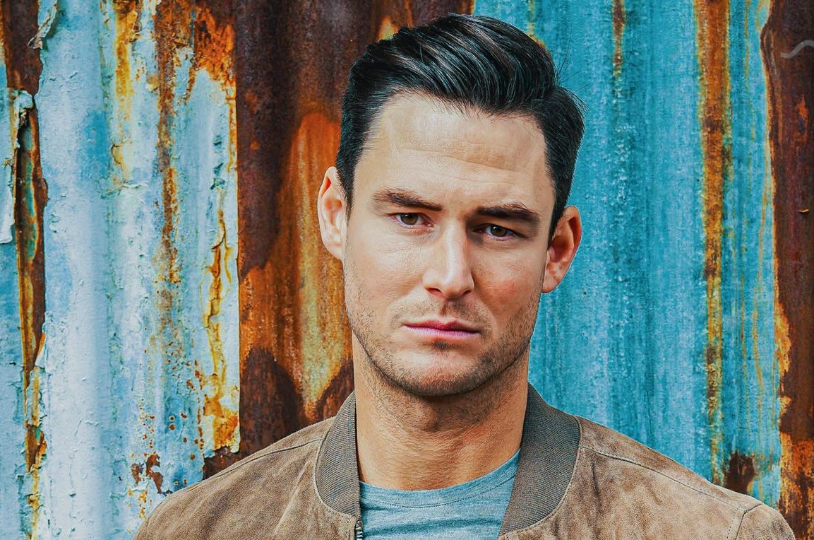 BBC EastEnders' Zack Hudson looking into camera