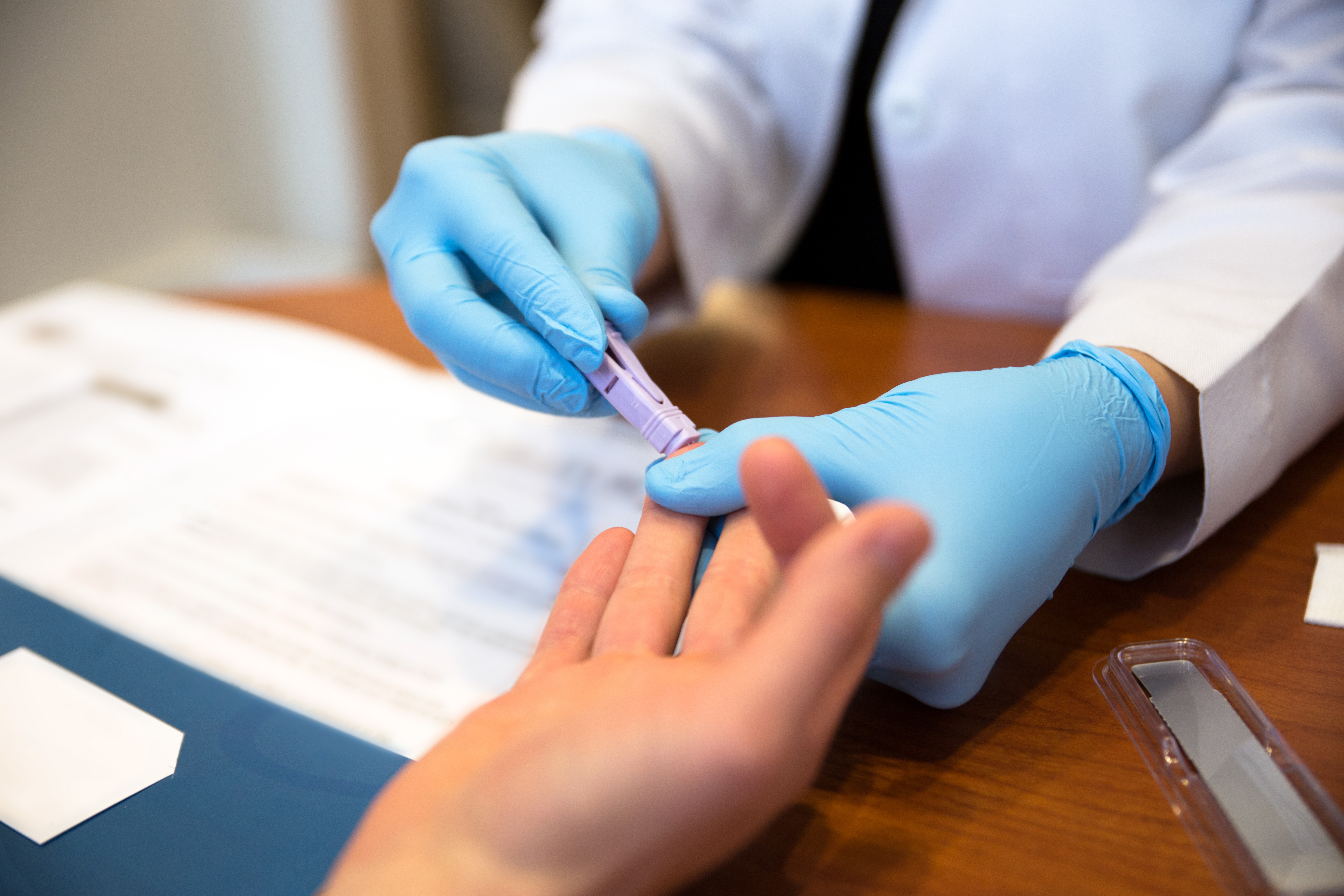 HIV fingerprick test A person having a fingerprick test.