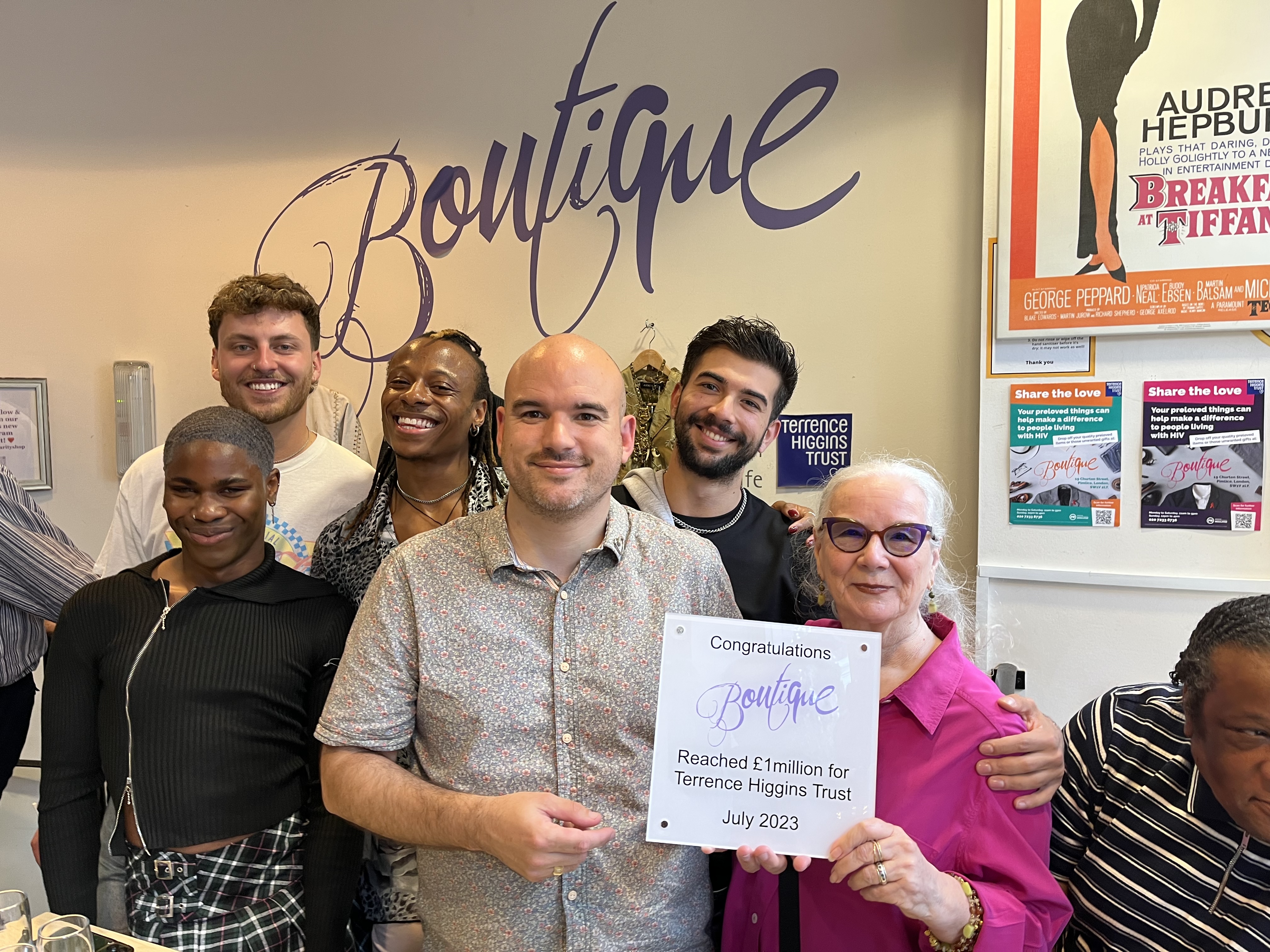 Boutique raises £1m. Chief Executive Richard Angell holds a sign congratulating the boutique with the cast of I Kissed A Boy.