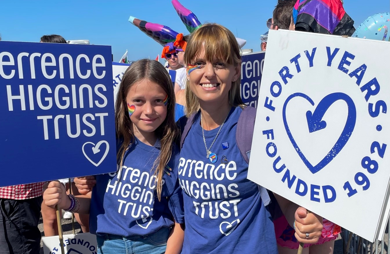 Emma Rutland and her daughter with placards at Brighton Pride.