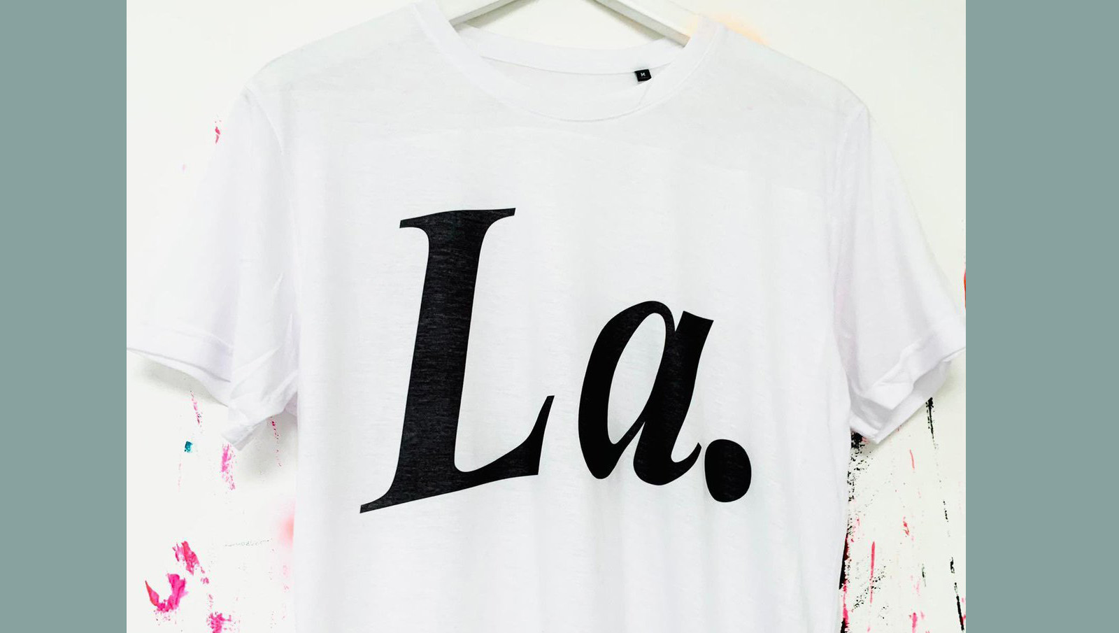 White T-shirt with 'La' black text on hanger