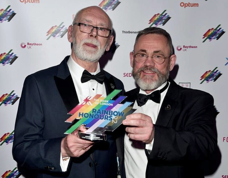 Martyn Butler OBE and Rupert Whitaker OBE holding award