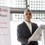 Sadiq Khan speaking in front of HIV Fast-Track Cities banner