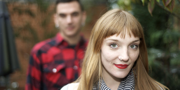 Woman in the foreground with man standing behind