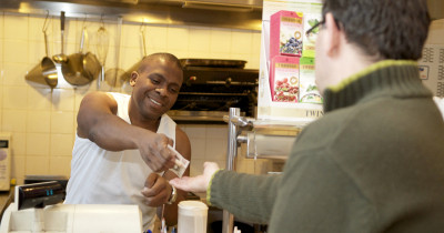 Shop worker handing over change