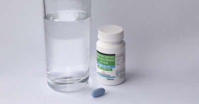 Ricovir PrEP pill and bottle with glass of water