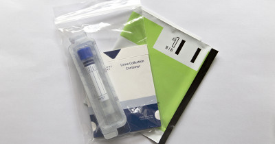 Chlamydia postal testing kit with collection tube and return envelope