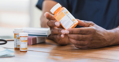 Bottle of pills in hand Bottle of pills in hand
