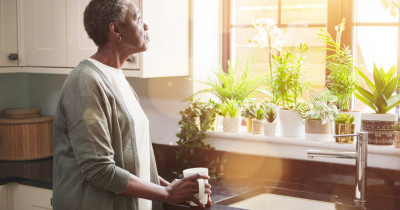 Woman standing at sink Woman standing at sink