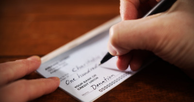 Signing a cheque.