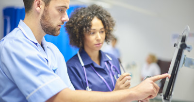 Healthcare professionals talking at screen Healthcare professionals talking at screen