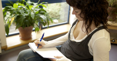 Women writing in a notebook