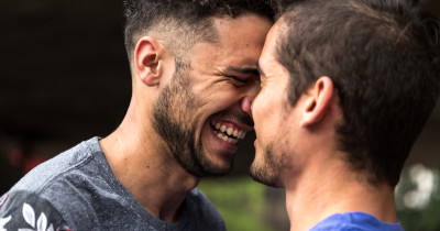 A couple face to face smiling