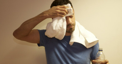 Man with towel and water after exercise