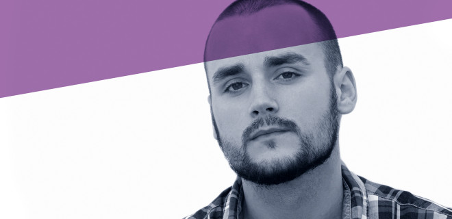 Man wearing a check shirt with counselling-branding purple banner. 