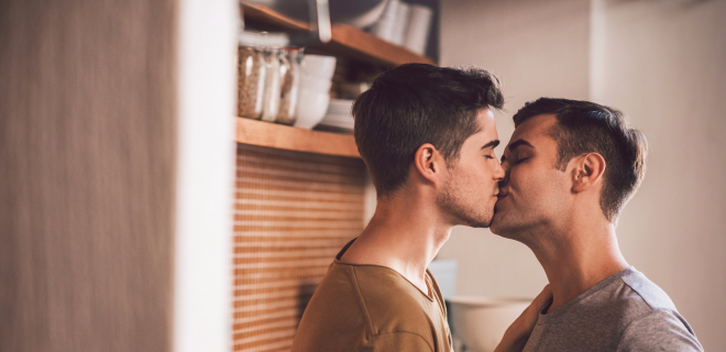 Two men kissing