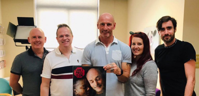Gareth Thomas holding Can't Pass It On poster with THT staff Gareth Thomas holding Can't Pass It On poster with THT staff
