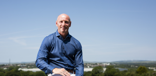 Gareth Thomas holding Tackle HIV rugby ball