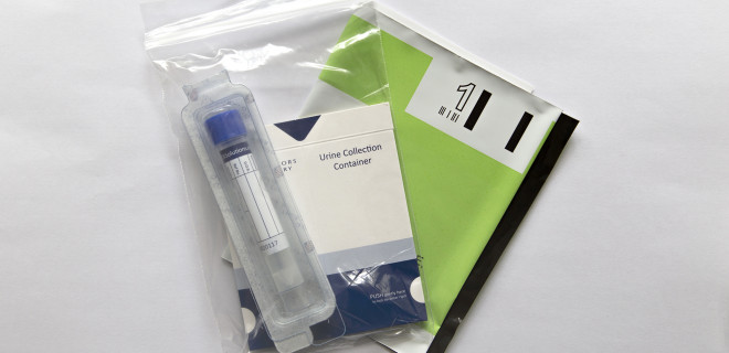 Chlamydia postal testing kit with collection tube and return envelope