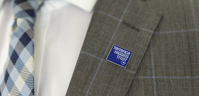 Terrence Higgins Trust lapel pin on a suit jacket