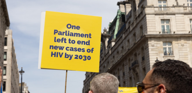 A placard held up reading "One Parliament left to end cases of HIV by 2023".