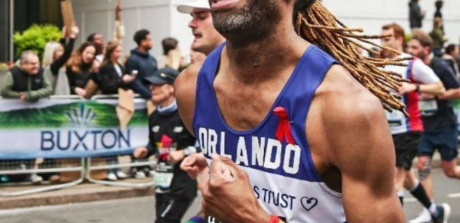 A smiling Terrence Higgins Trust marathon runner.