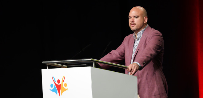 Richard Angell delivers a speech at the International AIDS Conference.