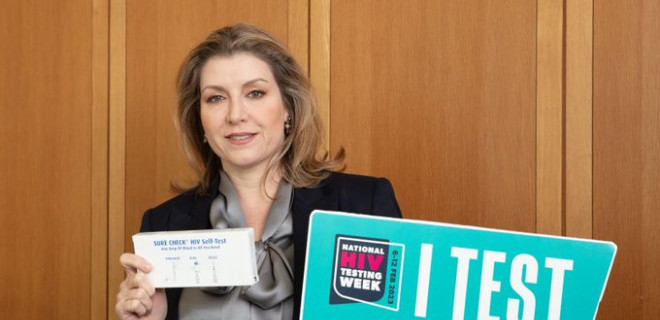 Penny Mordaunt holding up a test kit during National HIV Testing Week