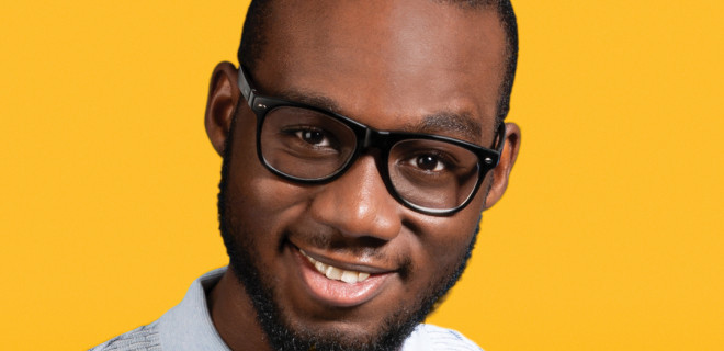 Man in glasses with yellow background