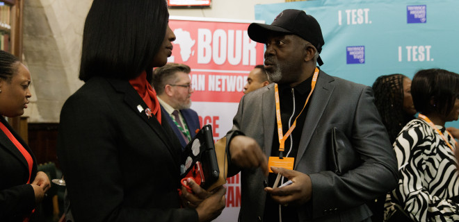A conversation between two individuals at a Terry Higgins Trust event.