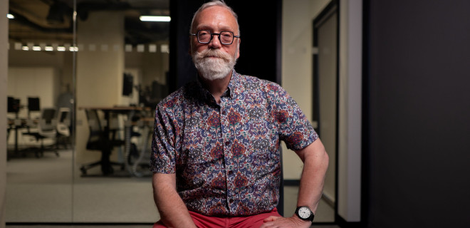 An elderly bespectacled and bearded man.