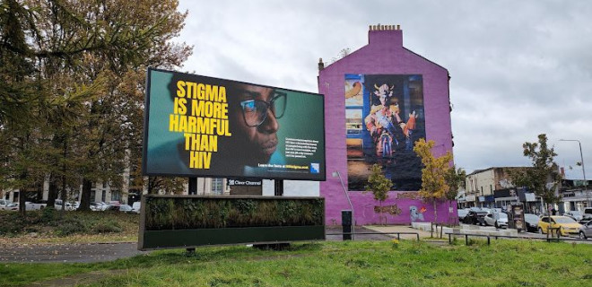 An outoodr digital billboard next to a house showing our anti-stigma messaging.